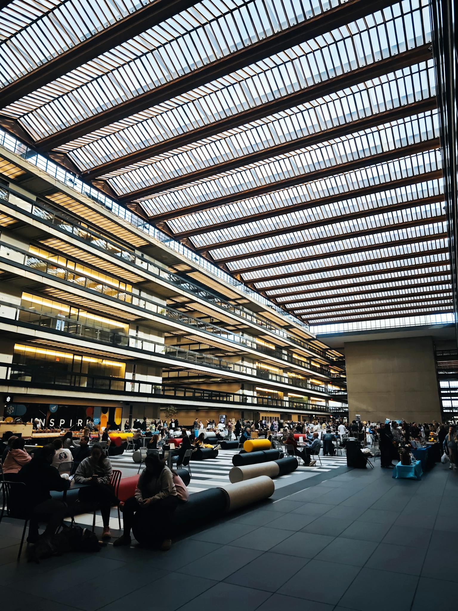 Spacious interior of Bell Works with a vibrant crowd and modern architecture in Holmdel, New Jersey.